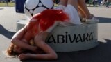 RUSSIA -- An activist attends a protest against torture, next to the World Cup mascot Zabivaka, outside the Saint Petersburg stadium in St. Petersburg, Russia July 3, 2018