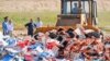 Russia -- A worker uses a bulldozer to crush crates of peaches outside the city of Novozybkov, about 600 km from Moscow, August 7, 2015