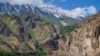 Road over a deep gorge. Below is a tumultuous river Panj. Pamir Highway, Tajikistan